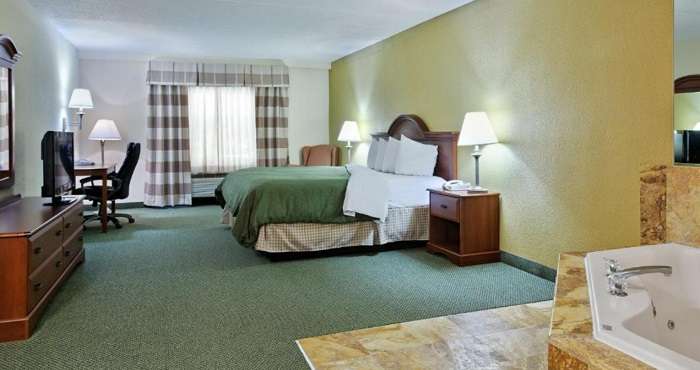 Suite with a spa tub in the room in Country Inn & Suites by Radisson, Charlotte University Place, NC